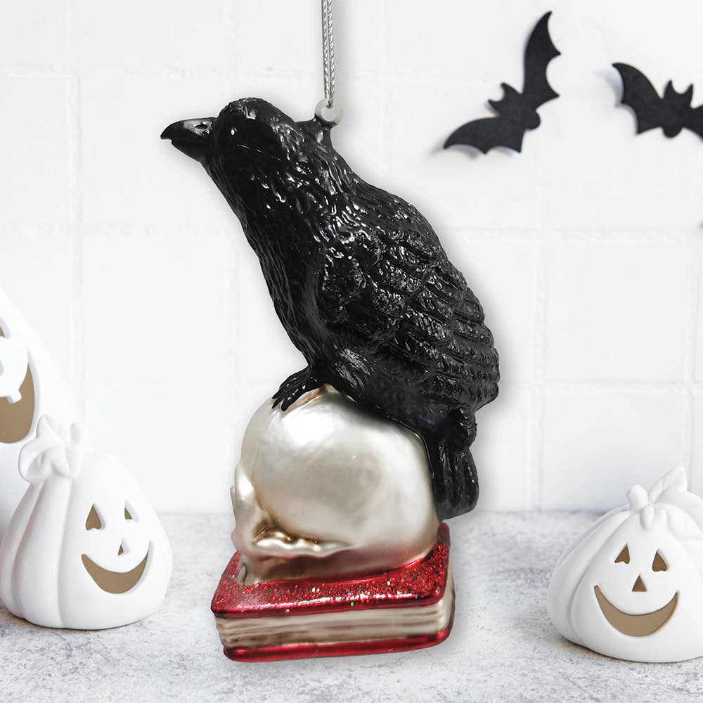 RAVEN ON SKULL AND BOOK GLASS HOLIDAY ORNAMENT