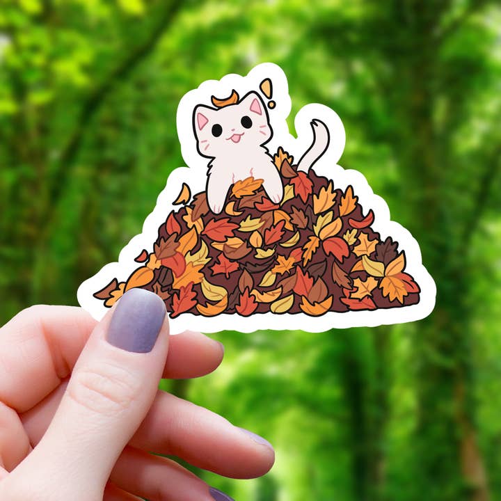 CAT IN PILE OF LEAVES STICKER