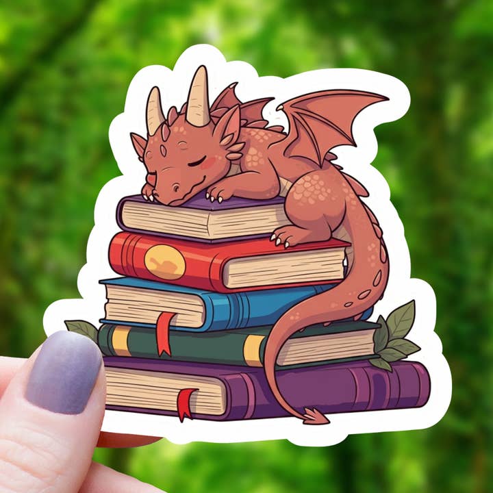 RED DRAGON SLEEPING ON BOOKS STICKER