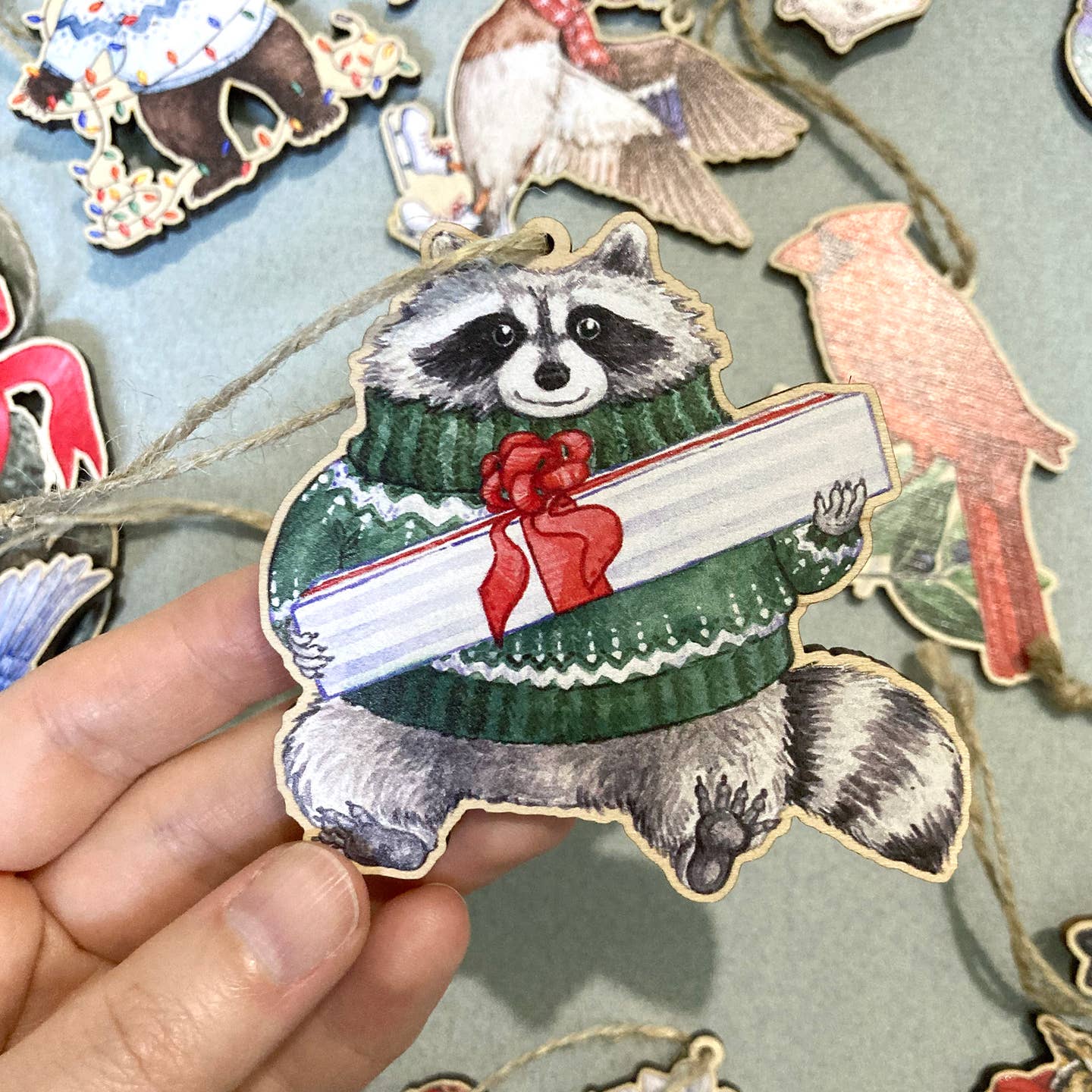 FESTIVE RACCOON WOODEN HOLIDAY ORNAMENT