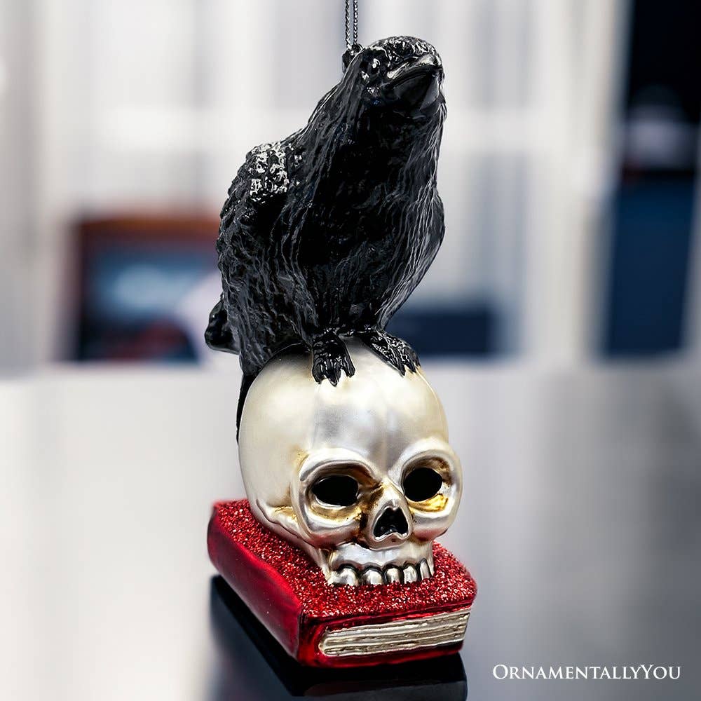 RAVEN ON SKULL AND BOOK GLASS HOLIDAY ORNAMENT