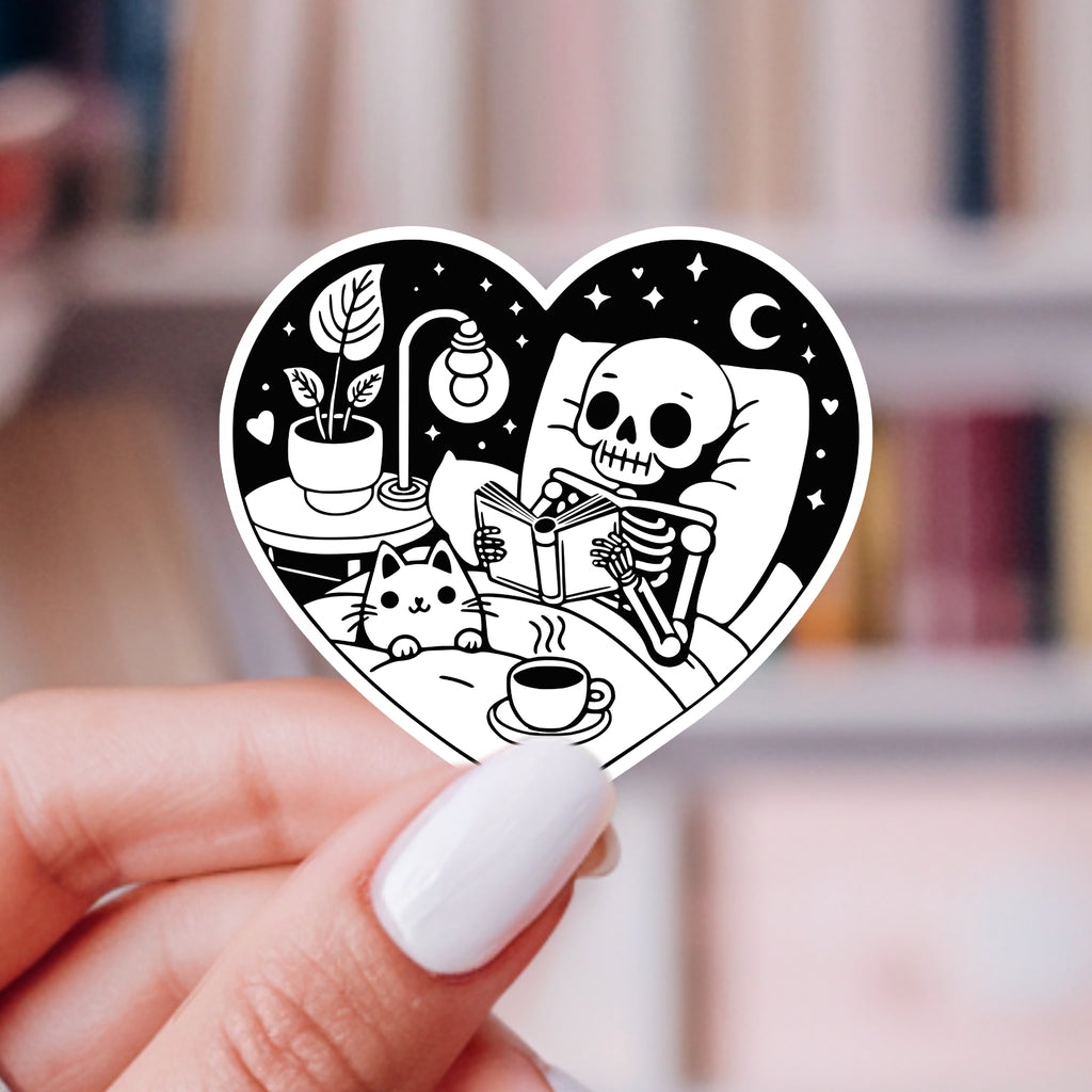 COZY SKELETON AND CAT READING STICKER