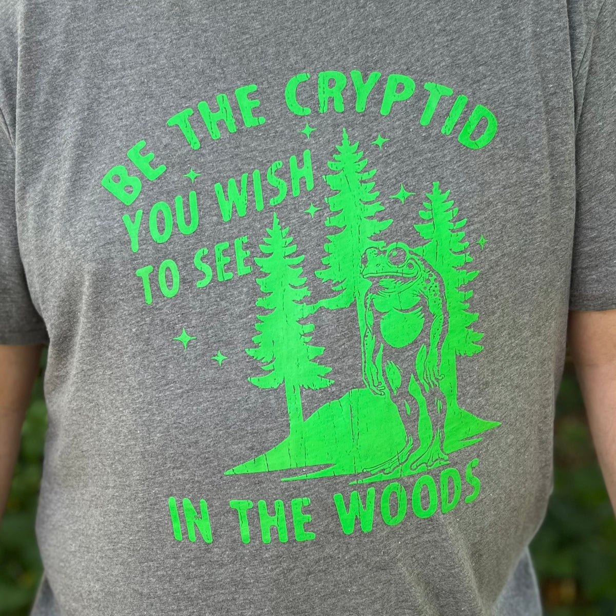 BE THE CRYPTID YOU WISH TO SEE IN THE WOODS T-SHIRT (HEATHER GRAY)